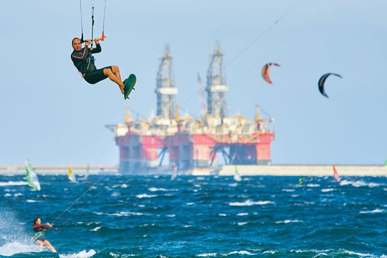 Kite surfer with tanker in the background