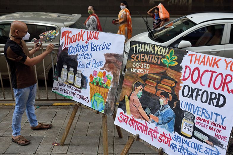 Man painting Thank You posters outdoors