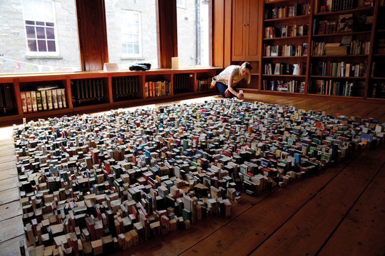 arranging books on floor