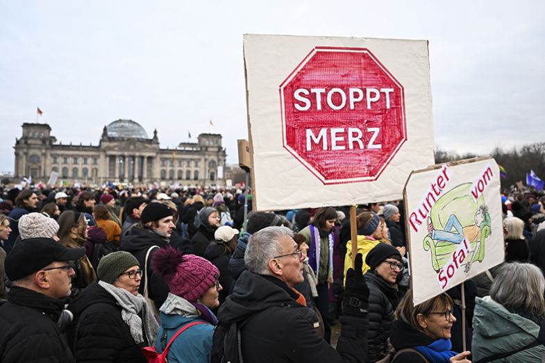 Protesters gather in front of the Reichstag building to oppose the Christian Democratic parties (CDU/CSU) for collaborating with the far-right Alternative for Germany (AfD) on a proposal to tighten immigration policies in Germany on 2 February 2025