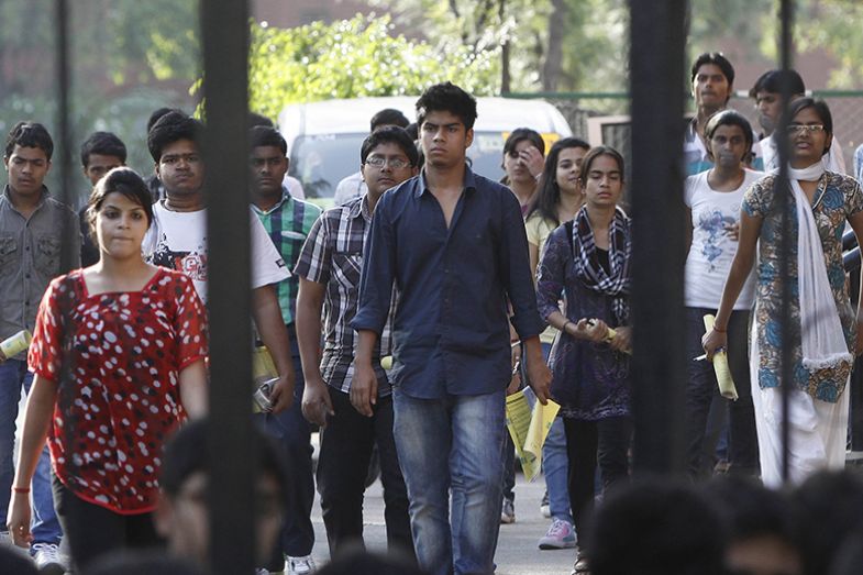 Students walk out of the examination centre after the IIT Joint Entrance exam, New Delhi, India