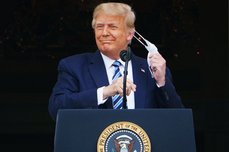 US President Donald Trump takes his mask off before speaking from the South Portico of the White House in Washington, DC during a rally on 10 October 2020. Trump spoke publicly for the first time since testing positive for Covid-19