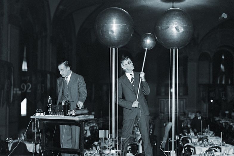 Scientists including Dr Vannevar Bush (right) demonstrating the Dr Robert Van De Graf 1,500,000 volt generator which, it is said, will be capable of producing a shock of 10,000,000 volts