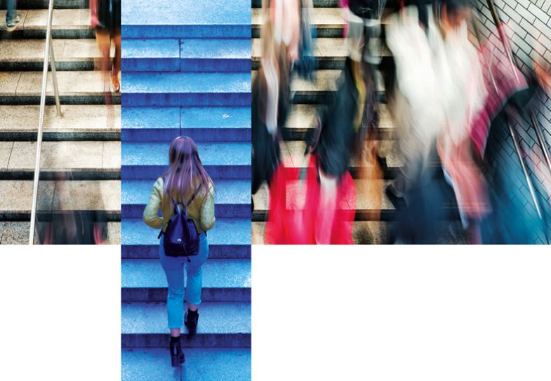 Montage of blurred crowd walking up stairs with a female walking up behind them