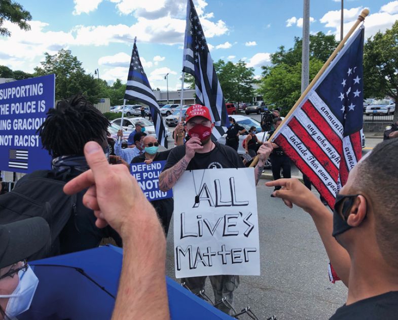 Protestors argue with a counter protester holding an "all lives matter" sign