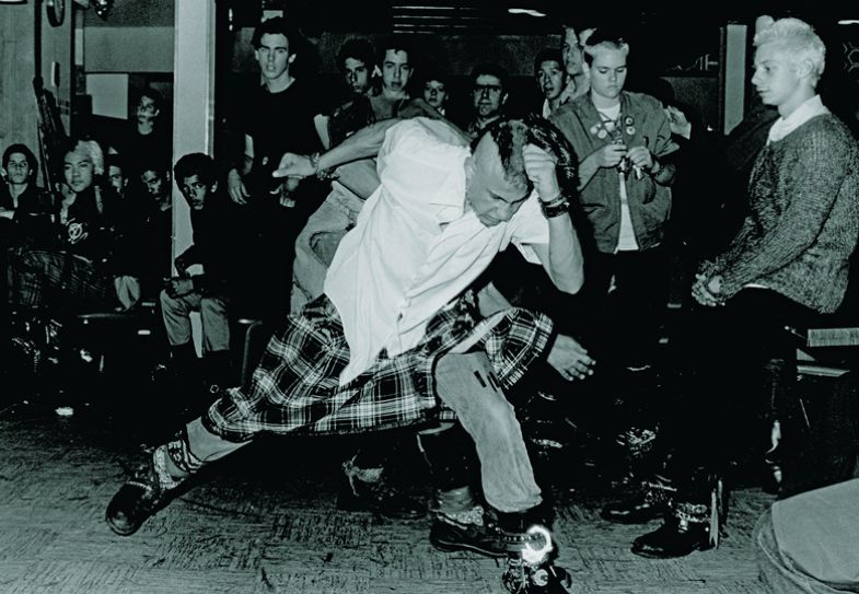 Audience members slam dancing at a punk music show in the Hong Kong Cafe in LA's Chinatown to illustrate Random beats deterministic