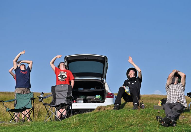 Enthusiasts launch rockets and all look up at the sky