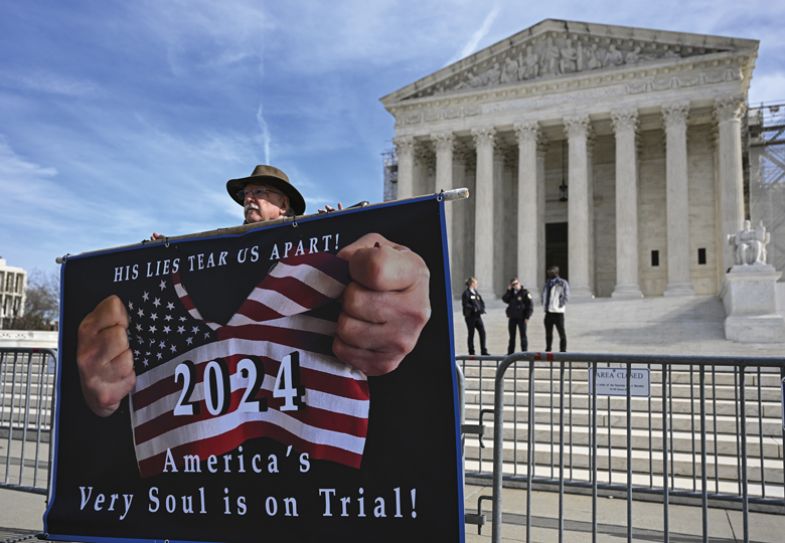 Demonstrators hold "Trump is a traitor" banners outside the US Supreme Court 