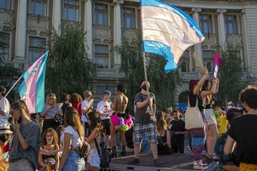 14.08.2021 Romania - Bucharest. A transsexual waving the trans pride flag on the stage set up at the University, at the lgbt pride parade.