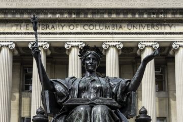 “Alma Mater,” a bronze statue by Daniel Chester French (1852-1931) welcomes students and visitors from the monumental staircase of Low Library at Columbia University.