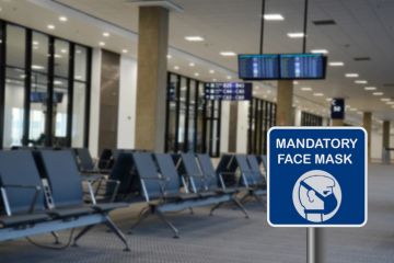 Blue sign warning that face mask is mandatory due to Covid-19 or coronavirus in airport
