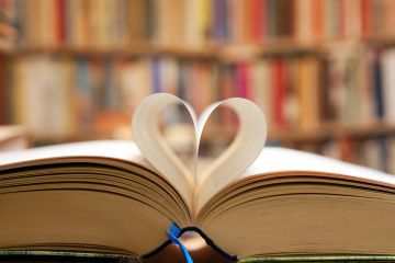 A book with its pages folded into a heart shape, symbolising publc support for universities