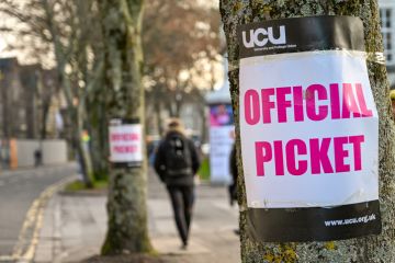 Cardiff, Wales - November 2019 Sign attached to a tree near an official picket line outside Cardiff University. It marks industrial action by members of the University and College Union.