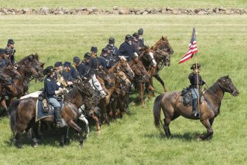 A lone cavalryman backed by numerous others