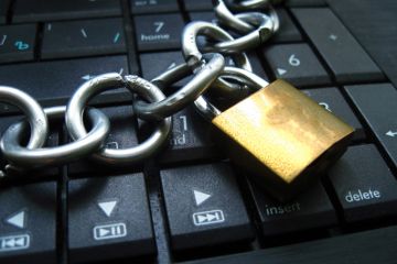 A padlock sits on a keyboard, symbolising censorship