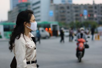 Chinese woman wearing a white face mask