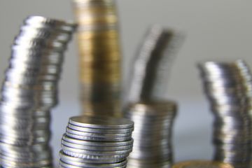 Wobbly towers of coins, symbolising unstable universities