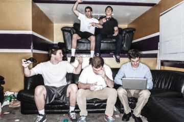 Five young men playing video games