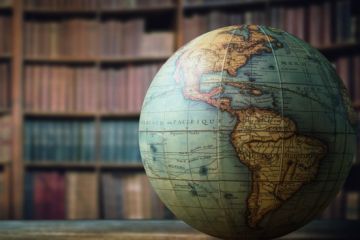 A globe in a library, symbolising internationalisation of higher education