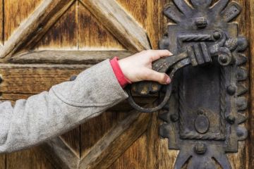 Hand opening old door