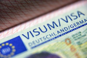 German visa stamp in passport close-up.