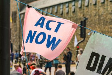 "Act now" banners in a climate change protest in Cardiff city centre.