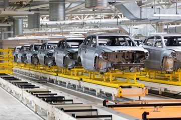 Partially built cars on production line