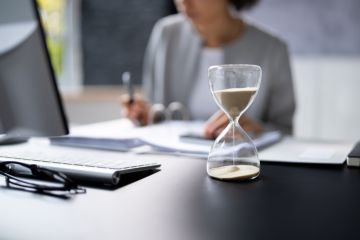Hourglass on desk running out