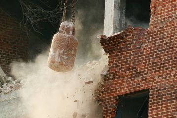 Action shot of a wrecking ball doing its work.