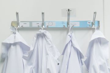 Lab coats on pegs