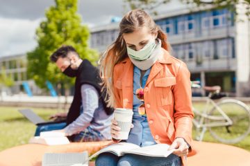 Man and woman practicing social distancing in university