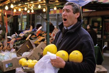 Market trader selling fruit, London