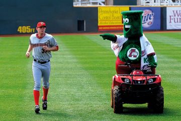 Mascot mocking baseball player