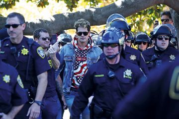 Milo Yiannopoulus surrounded by police