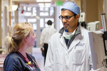 Nurse speaks with doctor. Stanford University Hospital and Clinics