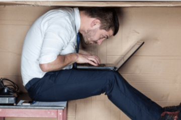 Man cramped in a box, cropped 