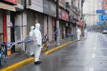 Shanghai.China-Jan.2021 new Covid-19 cases have emerged in China. Region has been locked down. Medical staff in white hazmat suit on street