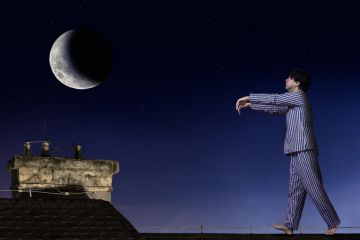 A man sleepwalking on a roof