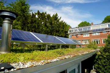 Solar panels on a sedum green rooftop garden in Helpman, Groningen