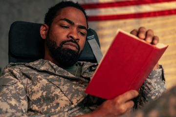 A soldier reading a book