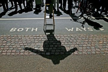 A speaker casts a shadow as he addresses a crowd at Speakers’ Corner in Hyde Park, London