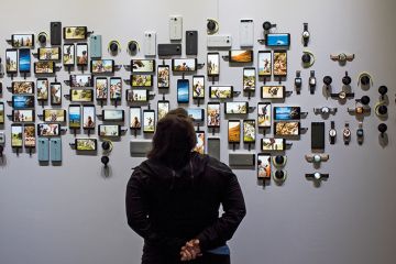 A person looking at various smart phones