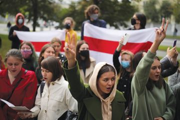 Students make V-signs as they stage a protest outside Minsk State Linguistic University. Mass protests erupted in major cities across Belarus after the announcement of the results of the 2020 Belarusian presidential election on August 9