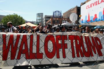 Cleveland, Ohio, USA - July 20, 2016: Participants in the 'Wall Off Trump' immigration march and rally demonstrate outside the Quicken Loans Arena, site of the Republican National Convention, on its third day. 