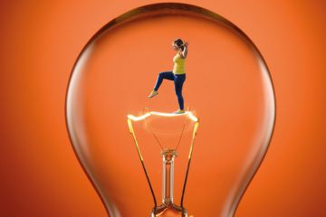 Montage of a close up image of a clear tungsten lightbulb with a person inside to illustrate  Spinout success needs less squabbling and more risk