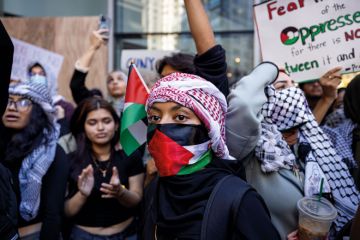 Students from Hunter College chant and hold up signs during a pro-Palestinian demonstration at the entrance of their campus to illustrate Israeli war revives academic freedom turmoil on US campuses