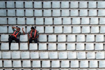 Officials sit among empty benches during the ninth match of the Asia Cup one-day cricket tournament to illustrate Indian PhD diaspora leaves universities short of recruits