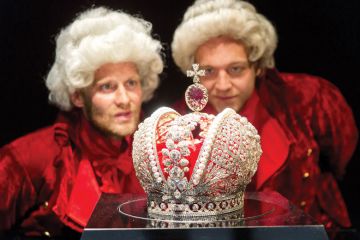 Two men in costume look at the model of the great tsars crown of the Russian Empire at the Hermitage in Amsterdam