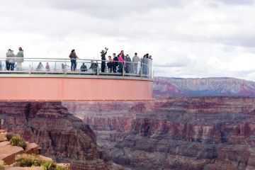 People standing on the The Skywalk on cantilever bridge in Arizona near the Colorado River