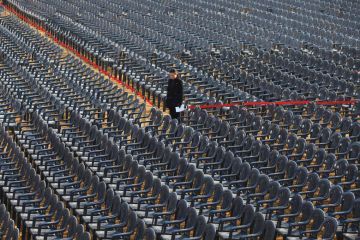 Person standing amongst empty seats as a metaphor for Concerns have been raised about the viability of some South Korean universities reported a record-high number of vacancies.